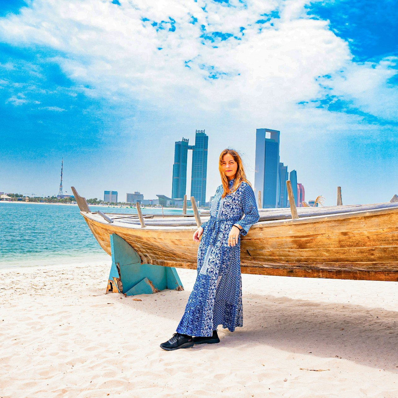 Experience the beauty of Abu Dhabi's skyline and serene beaches where traditional wooden boats meet modern architecture perfect for soaking in the essence of this remarkable city.